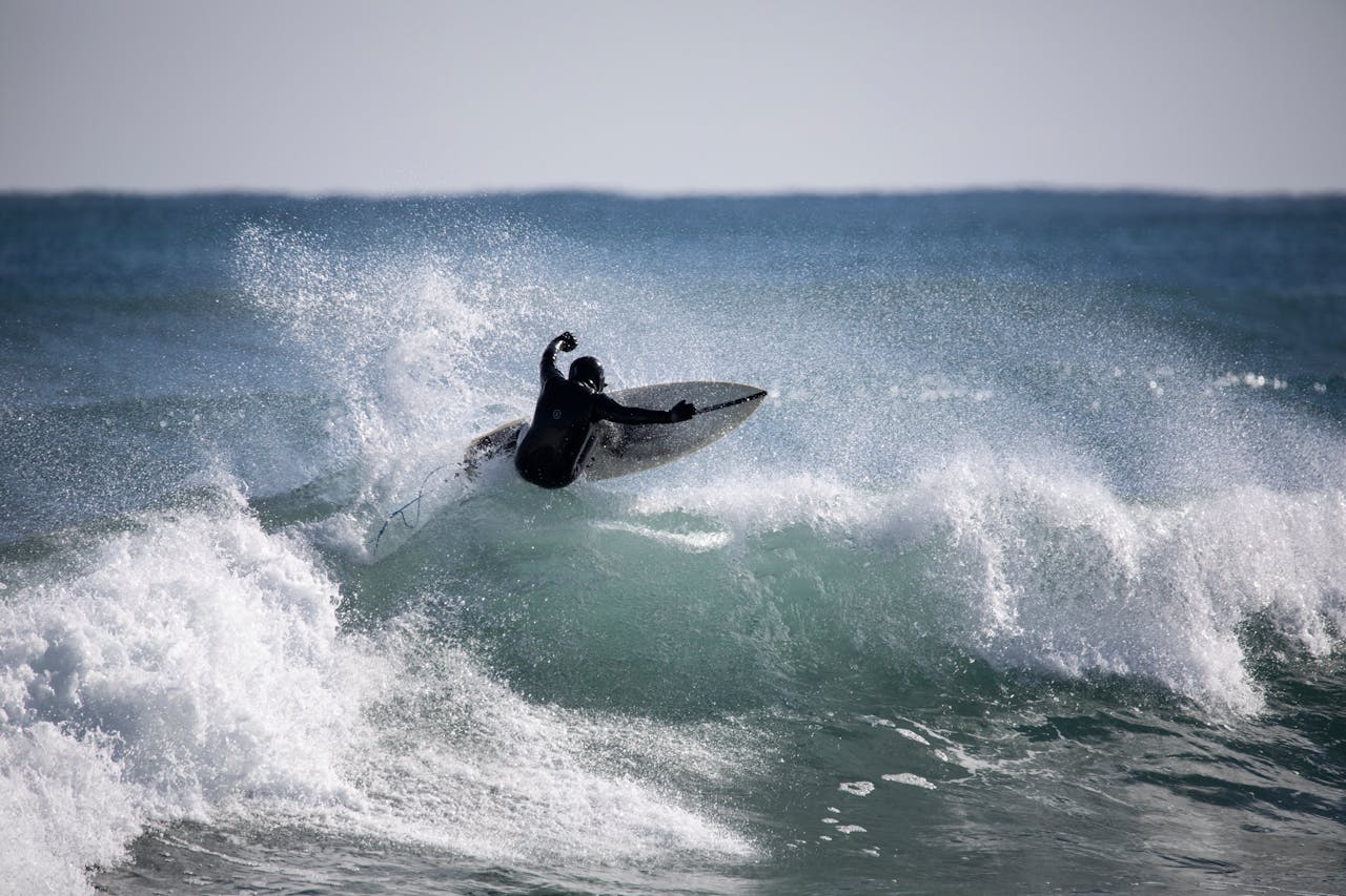 our-services-1 Surfer performing a daring maneuver on coastal waves in Yangyang, South Korea.