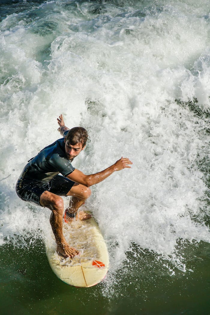 gallery-3 Experience the thrill of surfing with a skilled surfer riding high waves in dramatic action.