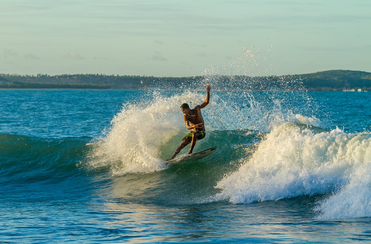 about-01 Surfer riding a wave in BaĆa Formosa, Brazil, showcasing skill and excitement.